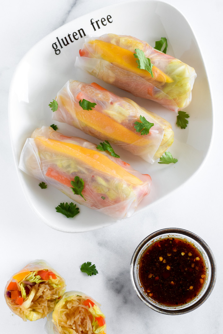 These gluten-free, dairy-free, and vegan homemade summer rolls are healthy and fresh. Made from rice noodles and sautéed veggies wrapped in rice paper sheets with a soy-garlic dipping sauce, this recipe can be made as a full meal or light appetizer.