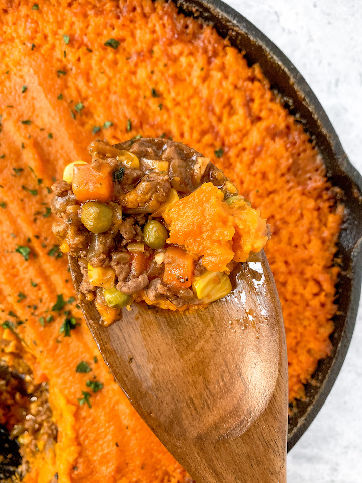This sweet potato shepherd's pie skillet is the ultimate cozy winter meal. With creamy sweet potatoes and a savoury filling of beef and vegetables, this easy dinner recipe is gluten free with a dairy free option. Made in one pot in just an hour, this meal is sure to be a family favourite!