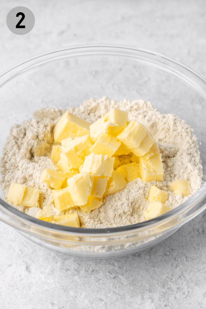 cubes of butter on top of dry ingredients in a bowl for pastry