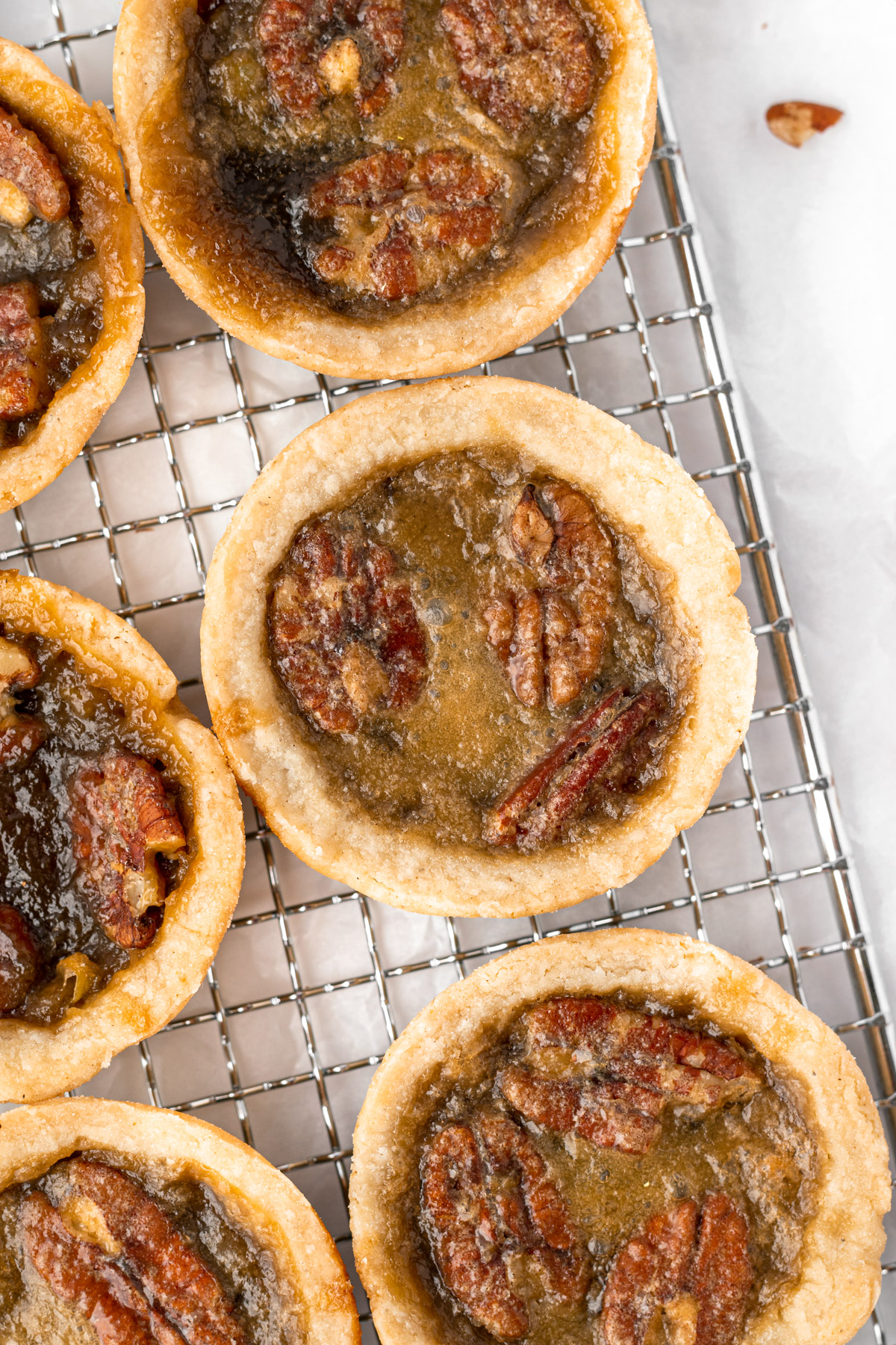 close up of butter tarts on a wire rack