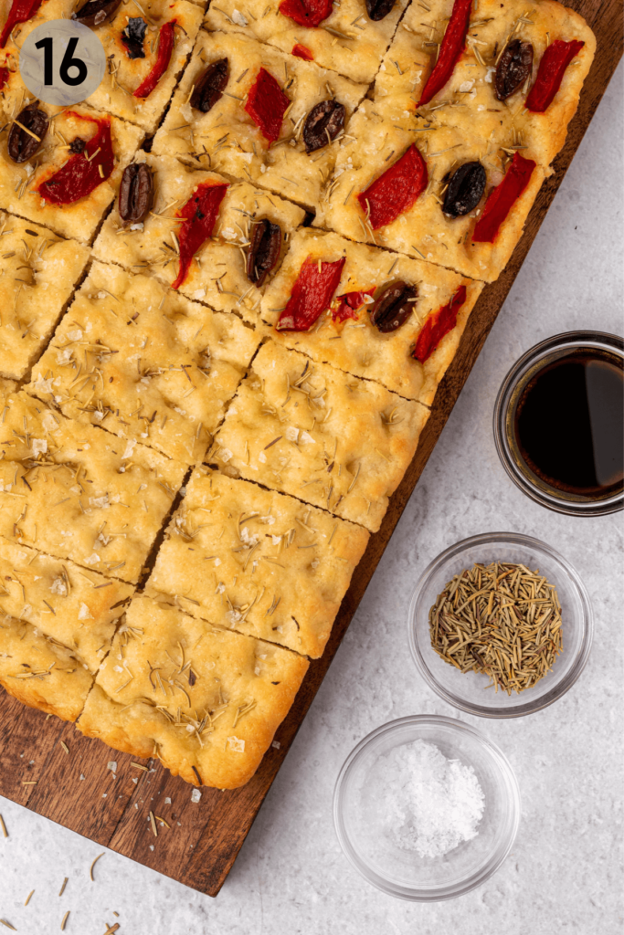 baked and sliced gluten free focaccia bread on a cutting board