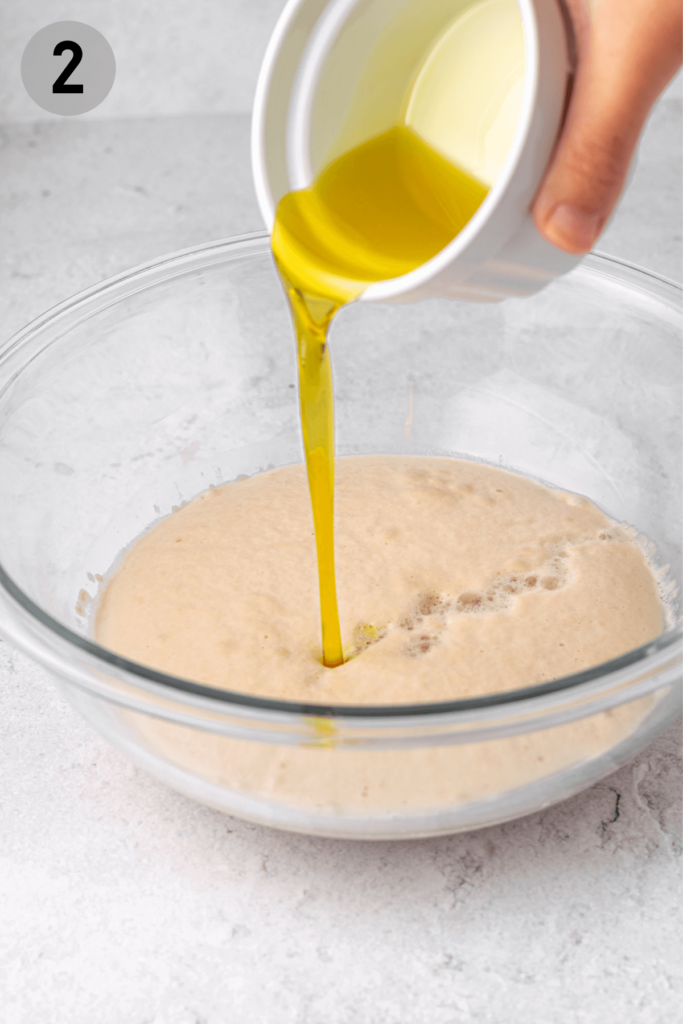 pouring olive oil into yeast