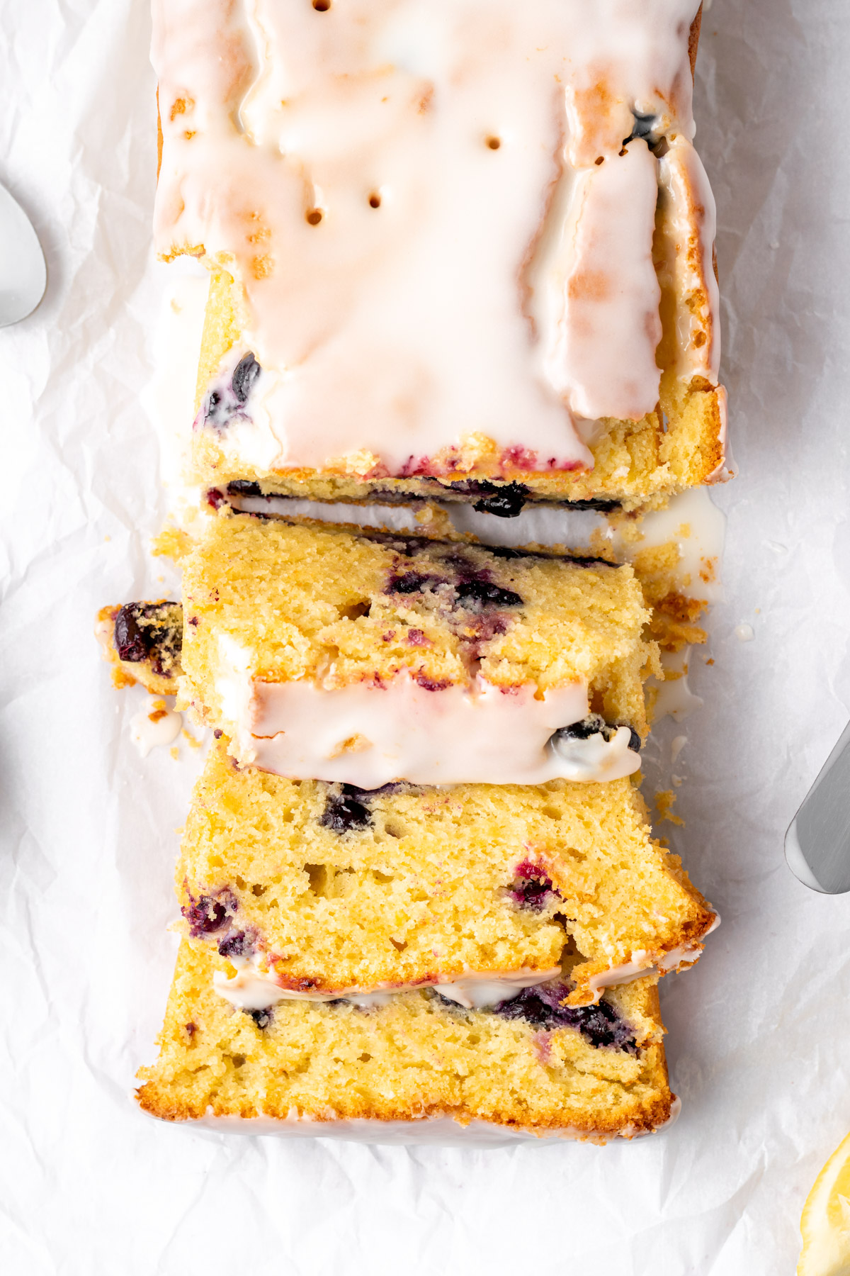 close up top view of a gluten free lemon blueberry loaf with 3 slices