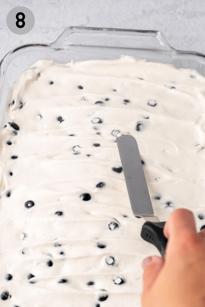 cheesecake filling being spread with a spatula