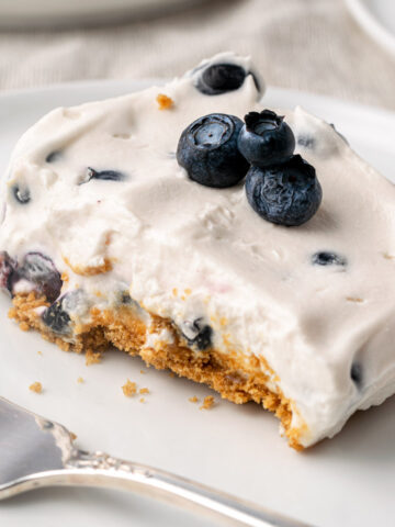 a slice of gluten free vegan blueberry cheesecake
