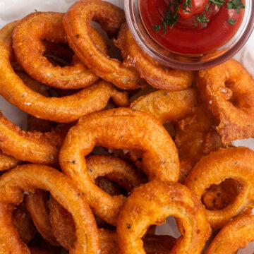 gluten free onion rings on a plate with ketchup