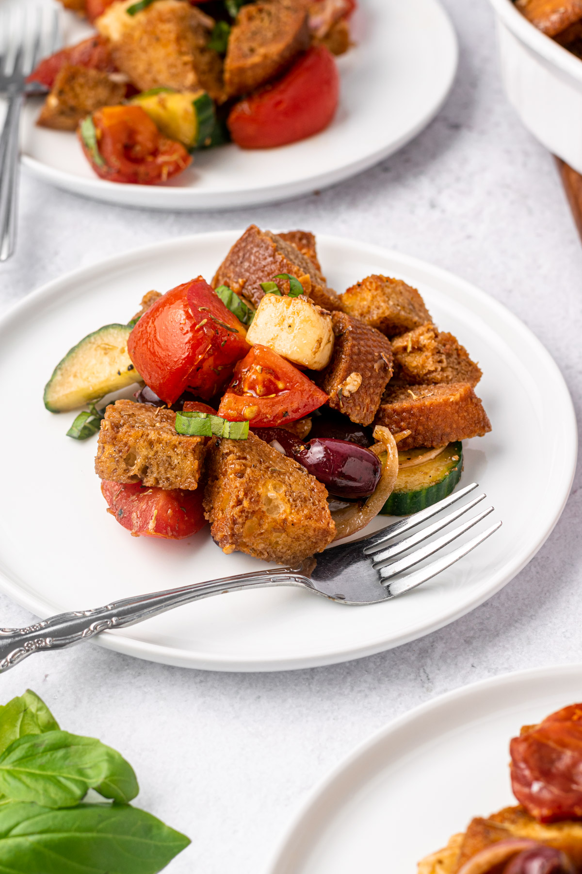 side view of panzanella salad on a plate
