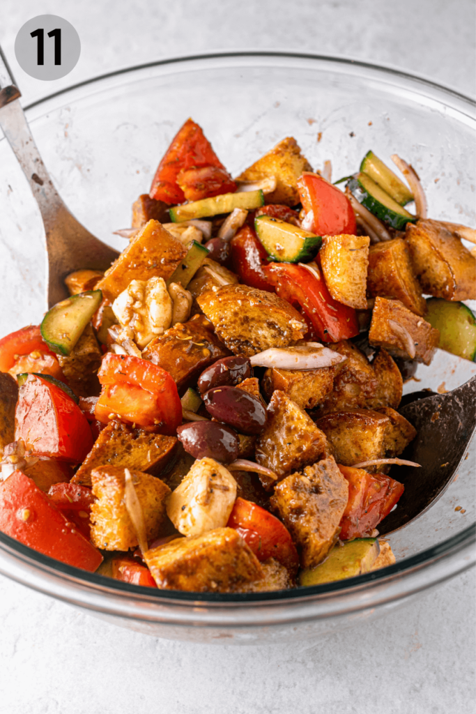 tossing panzanella salad with salad spoons