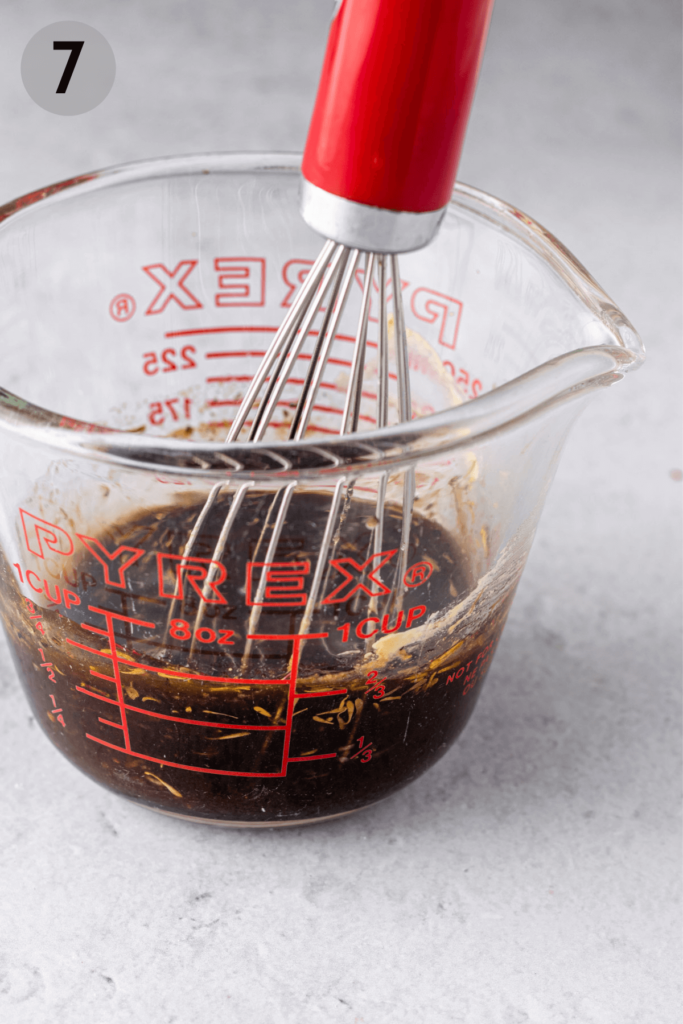 whisking dressing in a measuring cup