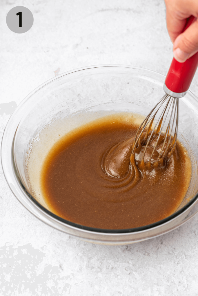 whisking butter and brown sugar together in a glass bowl