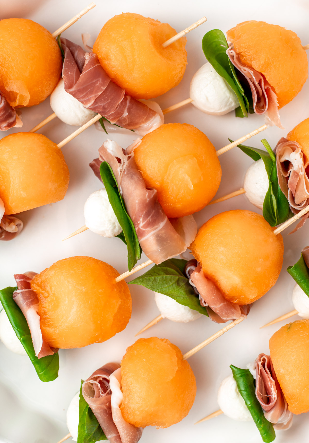 close up of melon prosciutto skewers
