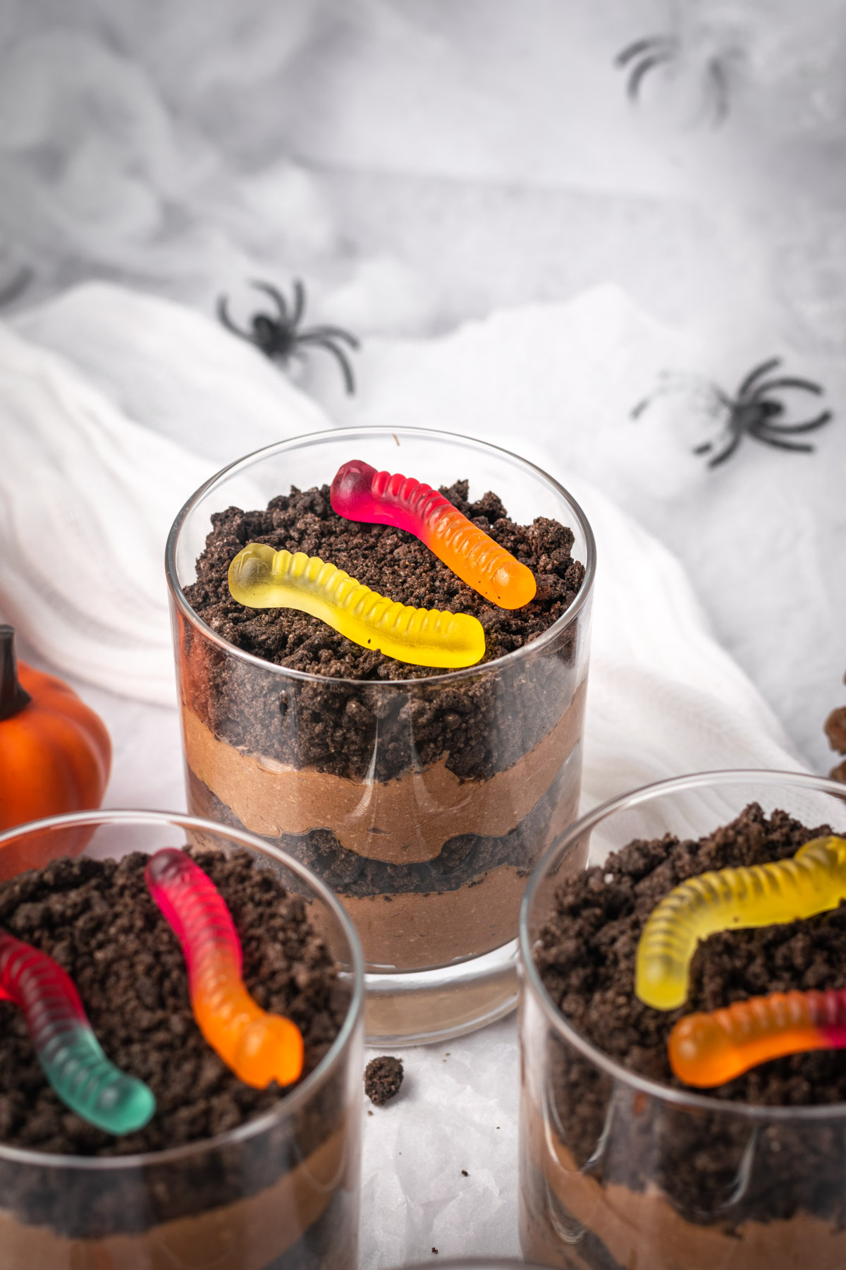 halloween dirt cups with spider webs in the background