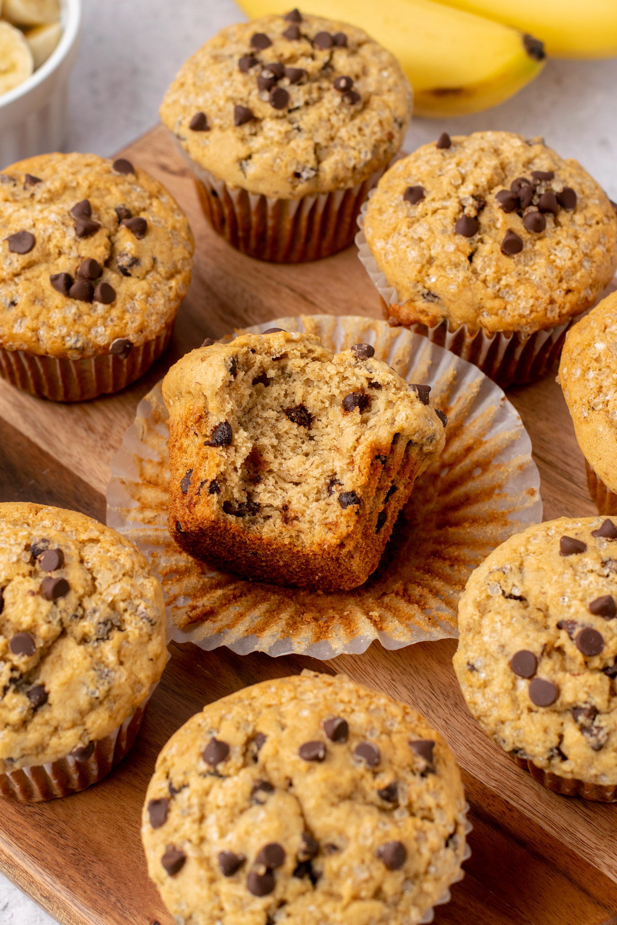 banana chocolate chip muffins, one with a bite missing
