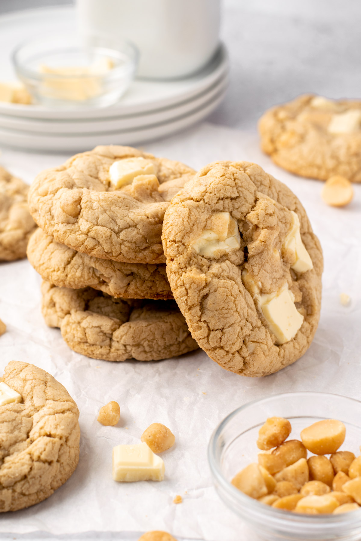 stack of 3 white chocolate macadamia nut cookies with one leaning