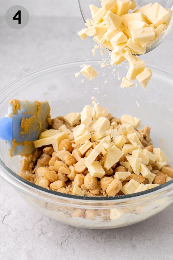 pouring white chocolate into cookie dough