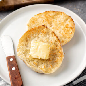 close up of toasted english muffin with a square of butter