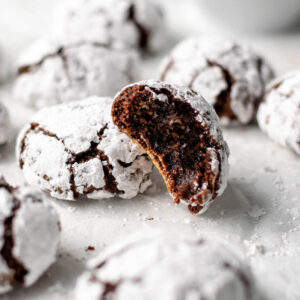chocolate espresso amaretti cookies with one with a bite missing.