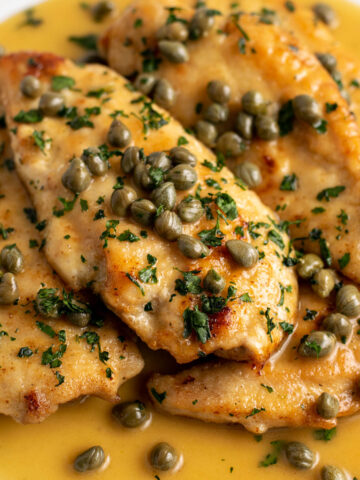 stacked chicken piccata on a plate.