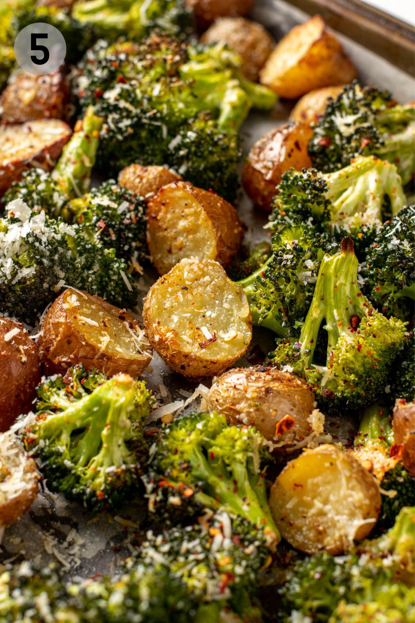 roasted broccoli and potatoes on a sheet pan.