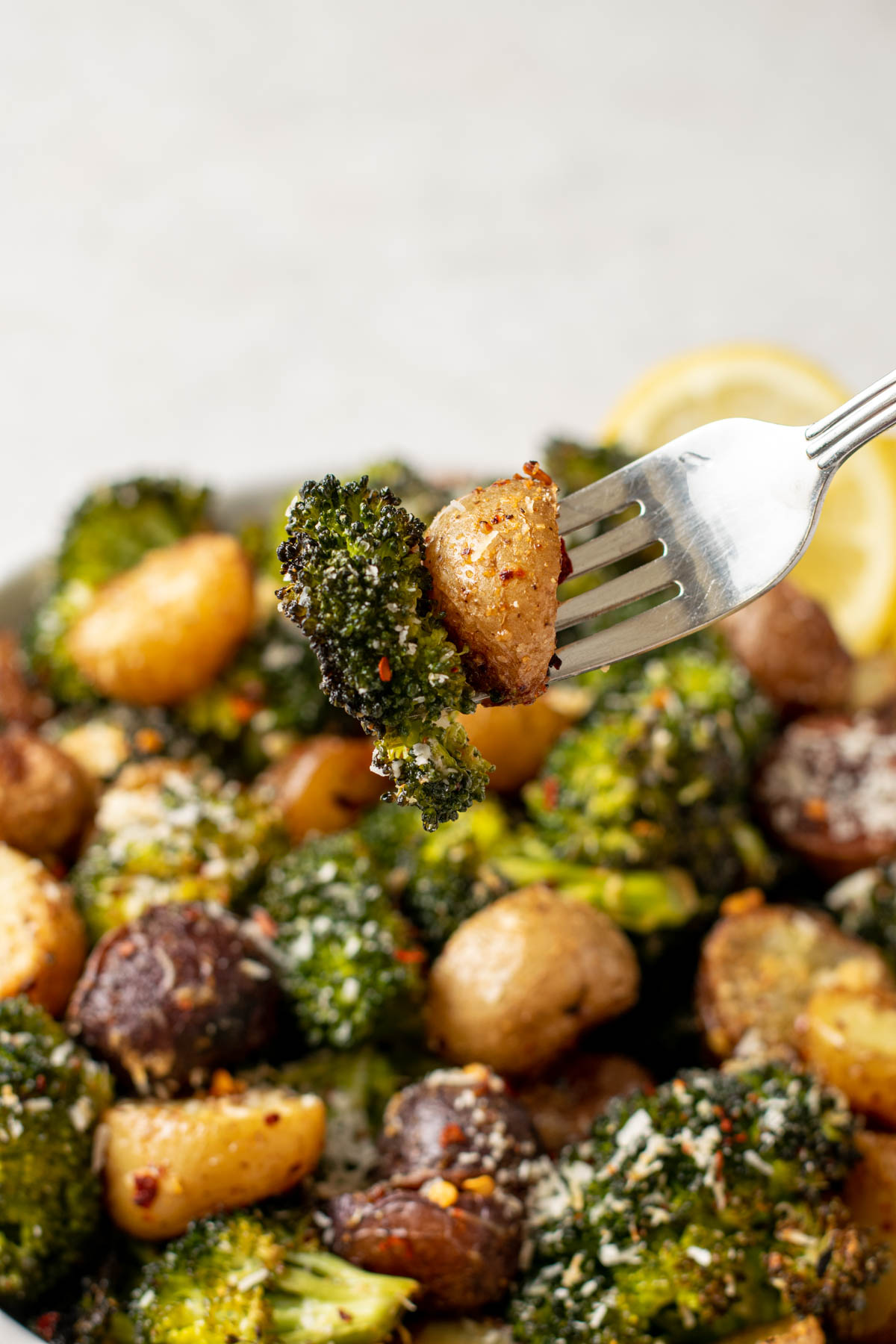 fork with roasted broccoli and potatoes.