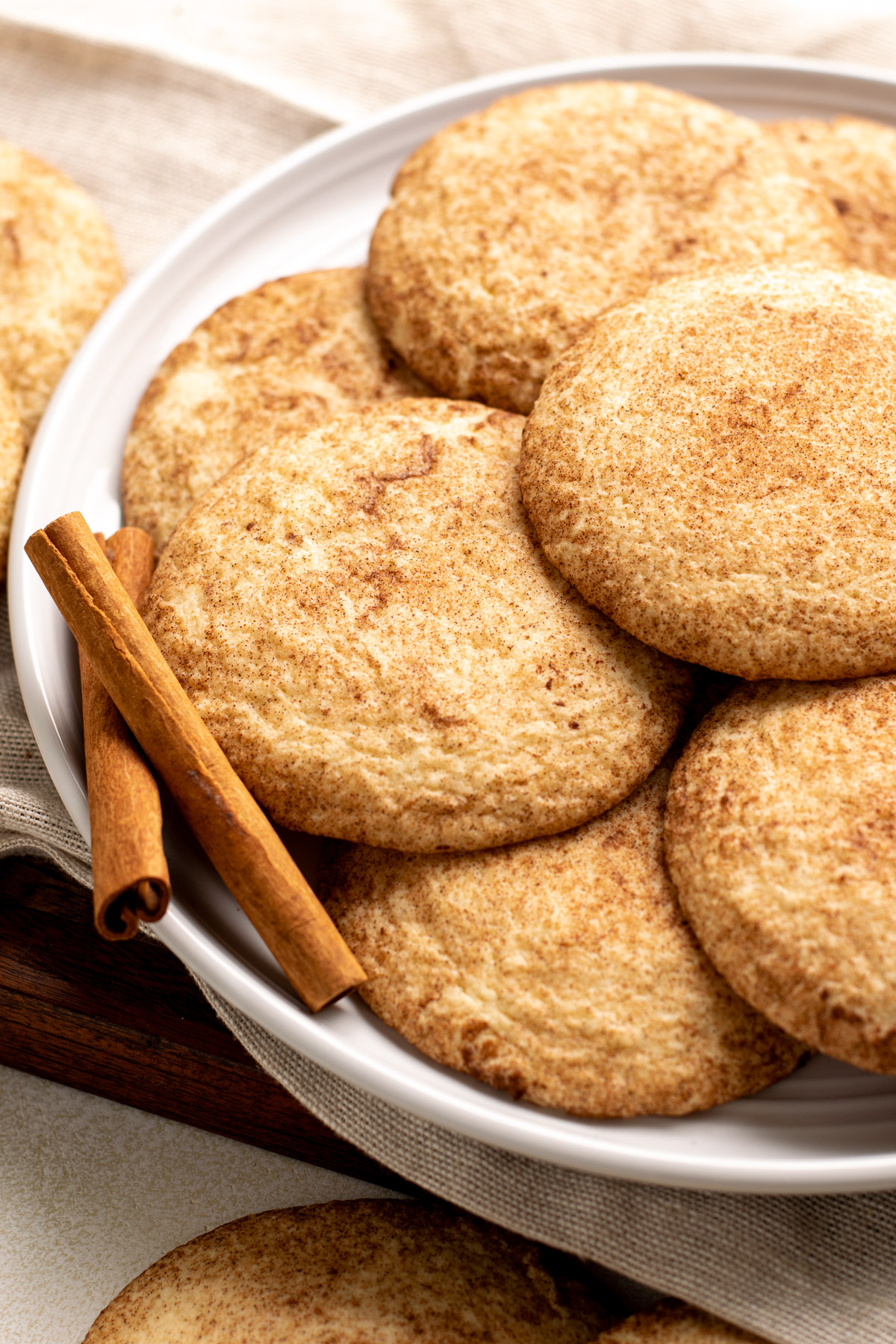 stack of gluten free snickerdoodle cookies on a white plate.