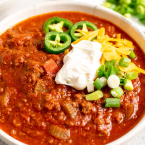 close up of no bean chili with garnishes on top.