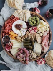 charcuterie meats and cheeses on a round board.