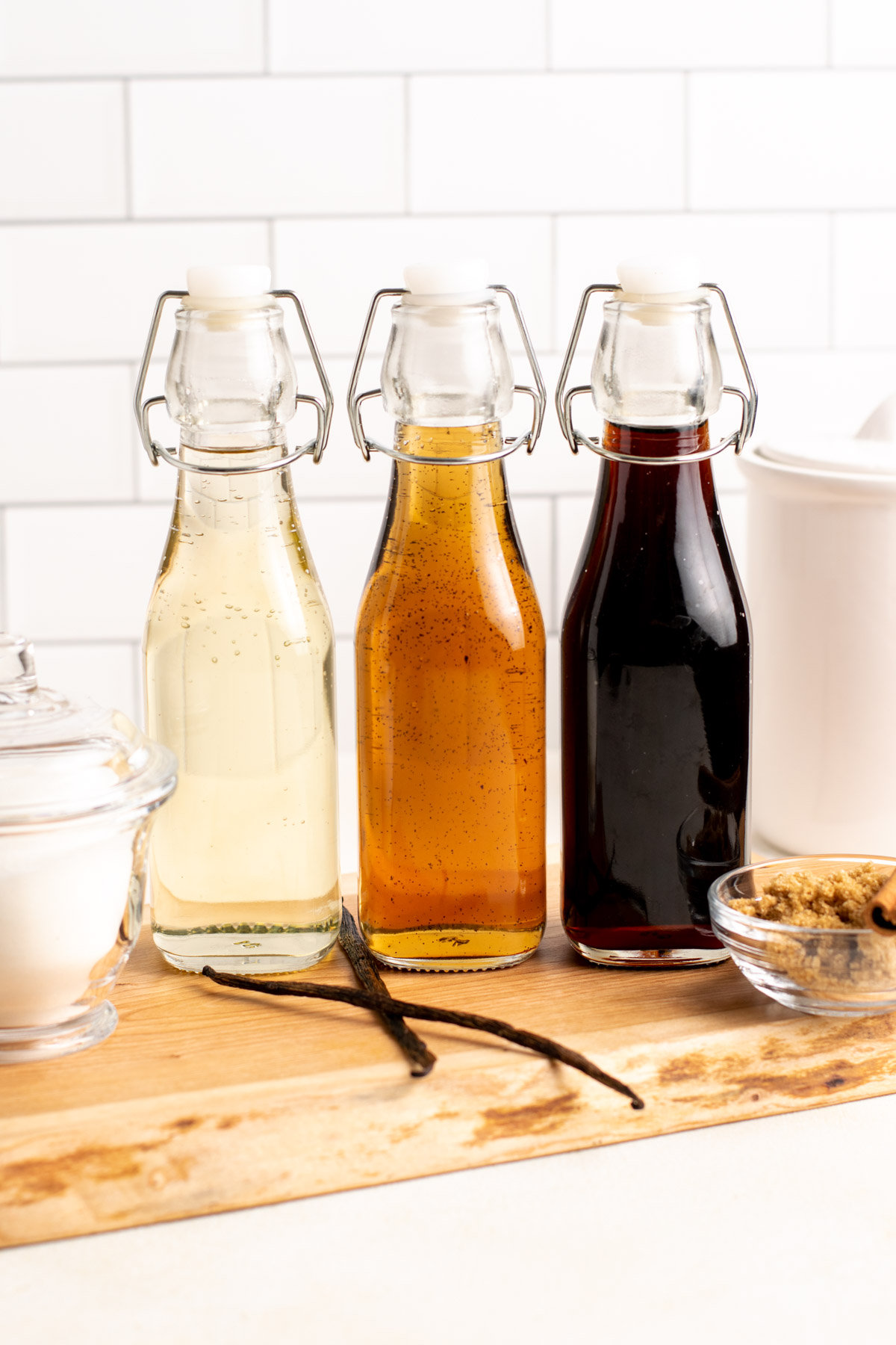 3 glass bottles of syrups, classic, vanilla, and brown sugar.
